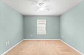 Southport house for rent - an empty room with blue walls and a ceiling fan