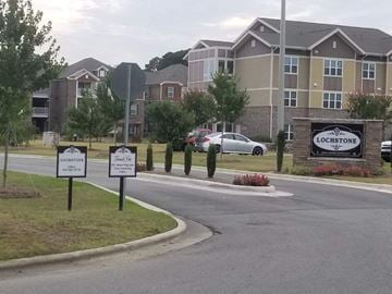 Goldsboro apartment for rent - an empty street with signs in front of an apartment building