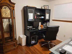 Tacoma apartment for rent - an office with a desk and a grandfather clock