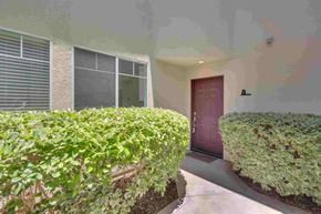 Aliso Viejo apartment for rent - a house with a red door and a hedge in front of it
