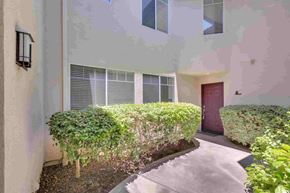 Aliso Viejo apartment for rent - a building with a sidewalk and a hedge in front of it