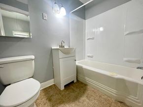 Louisville apartment for rent - a bathroom with a toilet and a tub and a sink