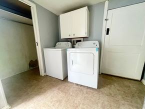 Louisville apartment for rent - an empty laundry room with two washes and a dryer