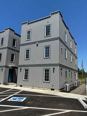 Salem apartment for rent - a gray building with a parking lot in front of it