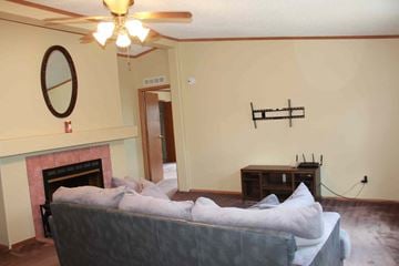 Trinidad house for rent - a living room with a couch and a fireplace