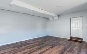 Louisville apartment for rent - a living room with a white door and wood flooring
