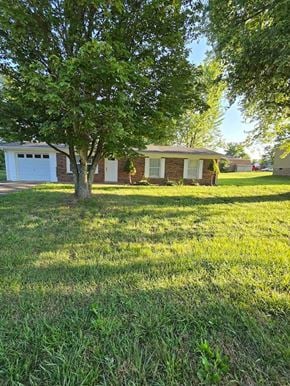 Mt. Sterling house for rent - a yard with a tree in front of a house