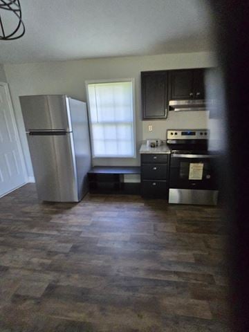 Mt. Sterling house for rent - a kitchen with a stainless steel refrigerator and a window
