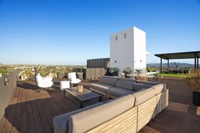 Los Angeles apartment for rent - A white building with a wooden deck and outdoor furniture.