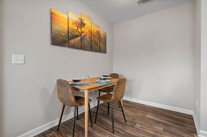 Columbus apartment for rent - a dining area with a table and chairs and a painting on the wall
