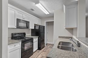 Columbus apartment for rent - a kitchen with black appliances and granite counter tops