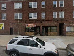 Chicago apartment for rent - a white car parked in front of a brick building