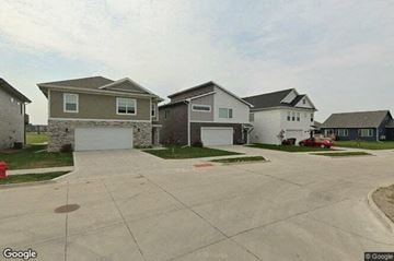 Grimes house for rent - a row of houses on a street with a driveway
