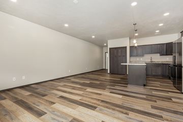 Sioux Falls apartment for rent - A kitchen with a wooden floor and a white wall.