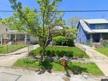 Cleveland house for rent - A tree in a front yard with a red fire hydrant.
