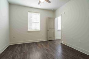 Montgomery apartment for rent - A room with a wooden floor and a ceiling fan.