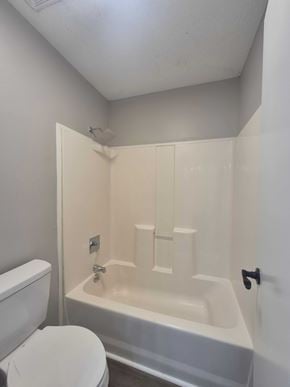 Oak Grove house for rent - A white toilet sits next to a white bathtub in a small bathroom.