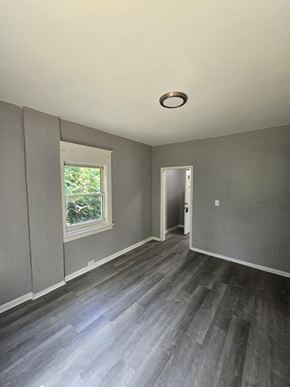 Cincinnati house for rent - a living room with grey walls and a window