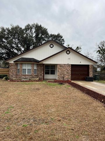 Hinesville apartment for rent - the front of a house with a lawn and a driveway
