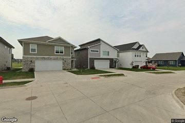 Grimes house for rent - a row of houses on a street with a driveway