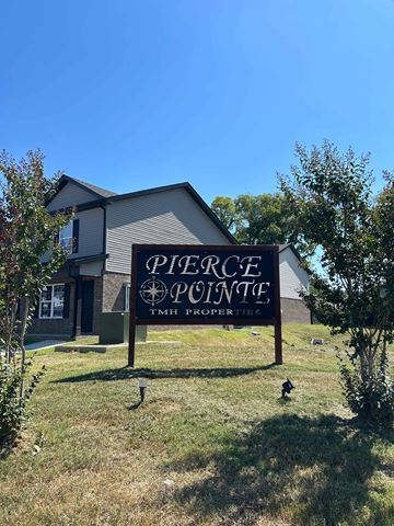 Shelbyville apartment for rent - A sign for Pierce Pointe TMH Properties in front of a house.