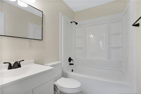 Fayetteville house for rent - a bathroom with a sink toilet and a tub
