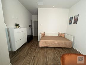 Atlanta house for rent - a small bedroom with a bed and a refrigerator