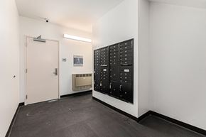 Detroit apartment for rent - A black control panel with white numbers and letters is on a white wall.
