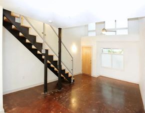 Richmond apartment for rent - an empty living room with a staircase and a door