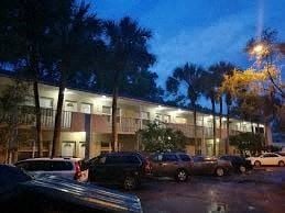Gainesville apartment for rent - a parking lot filled with cars in front of a building