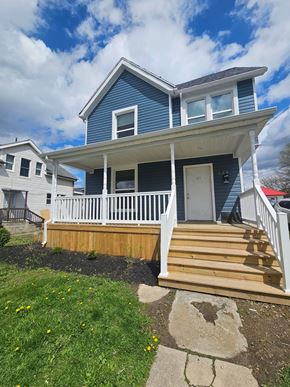 Lima apartment for rent - A blue house with a white porch and a wooden deck.