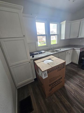 Lima apartment for rent - A kitchen with a box labeled Dishwasher on the floor.