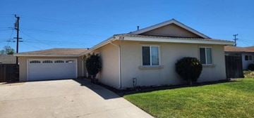 Santa Maria house for rent - A house with a white garage door and a brown roof.