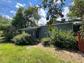 Boulder apartment for rent - a green house with bushes in front of it