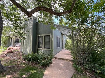 Boulder apartment for rent - a green house with trees and a sidewalk