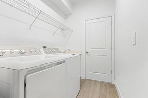 Estero house for rent - A white washer and dryer in a small laundry room.