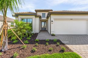 Estero house for rent - A house with a white garage door and a driveway.