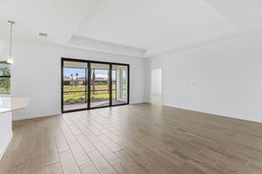 Estero house for rent - A spacious room with a sliding glass door leading to a garden.