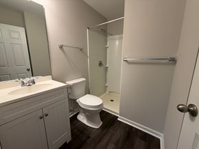 Rock Hill apartment for rent - A white toilet sits in a bathroom next to a walk-in shower.