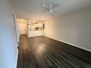 Rock Hill apartment for rent - A room with a kitchen in the background and a wood floor.