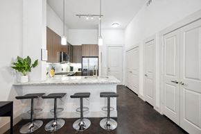 Richardson house for rent - a kitchen with a counter top and stools
