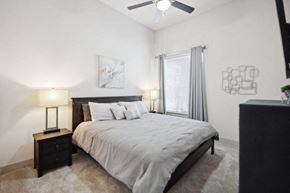 Richardson house for rent - a bedroom with a bed and a ceiling fan
