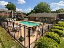 Montgomery apartment for rent - A black fence surrounds a green pool.