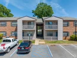Montgomery apartment for rent - A parking lot in front of a two-story apartment building with cars parked.