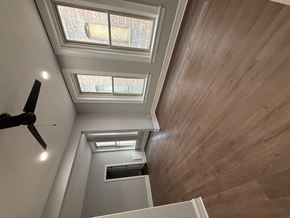 Sioux City apartment for rent - A ceiling fan is on the left side of a room with wooden walls and ceiling.