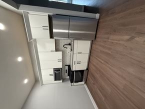 Sioux City apartment for rent - A modern kitchen with wooden flooring and white cabinetry.