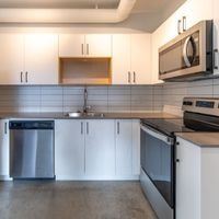 Victoria apartment for rent - A kitchen with white cabinets and a stainless steel dishwasher.