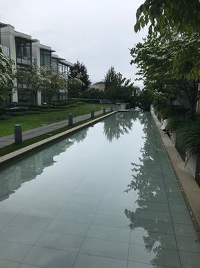 Vancouver apartment for rent - A long, narrow reflective pool in the middle of a grassy area.