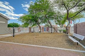 North Las Vegas apartment for rent - A park with a bench, a playground and a tree.