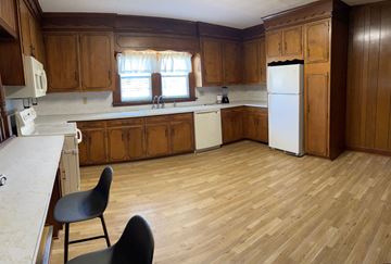 Benson house for rent - an empty kitchen with wooden floors and wooden cabinets